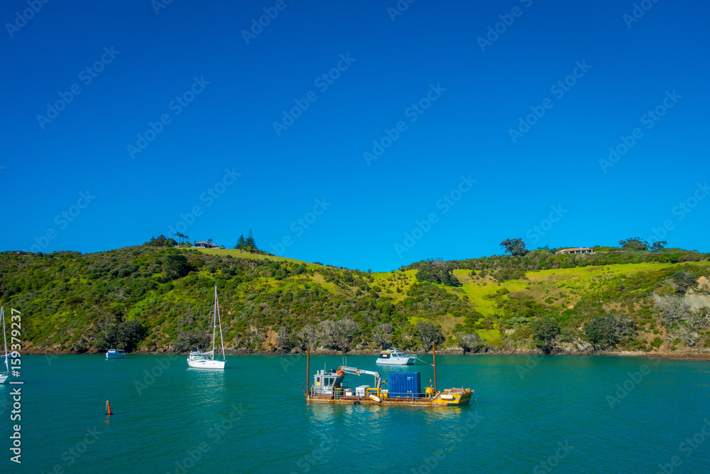 Sailing yachts in Waiheke Island, New Zealand. with a beautiful blue sky and magenta water in a sunny day