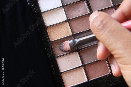 eyeshadow brown tone in cosmetic palette on black background have copy space