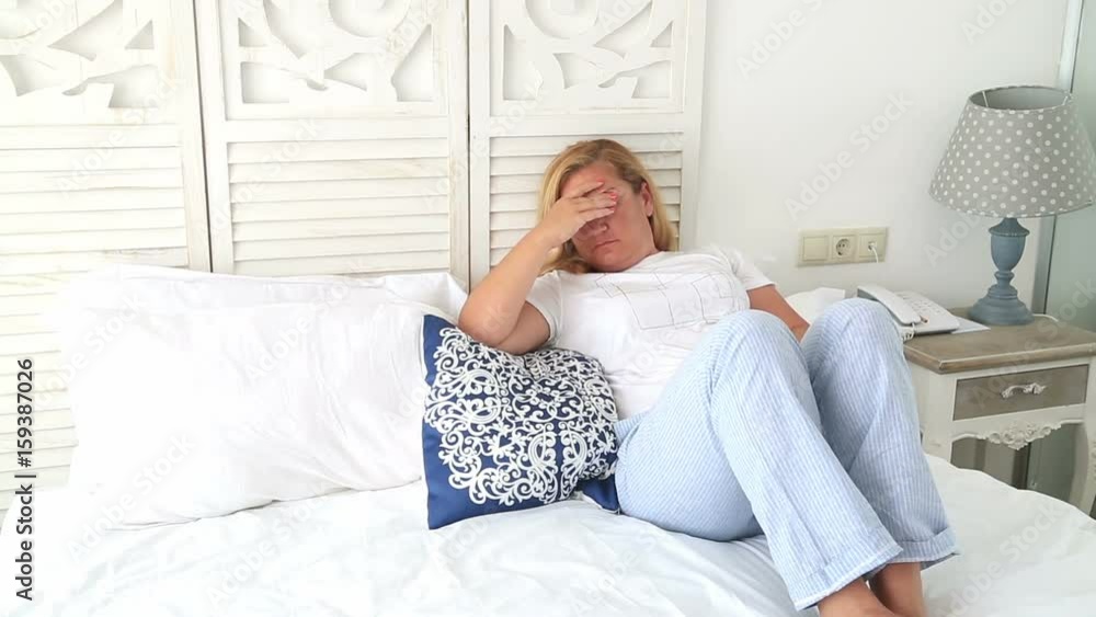 Thoughful Sad Woman Lying On A Bed Alone Thoughful Sad Woman Lying On A Bed Alone
