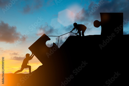 Silhouette team business helps to systematically patience hard work and the pressure to reach the finish line over blurred natural. Motivate employee growth concept. jigsaw photo