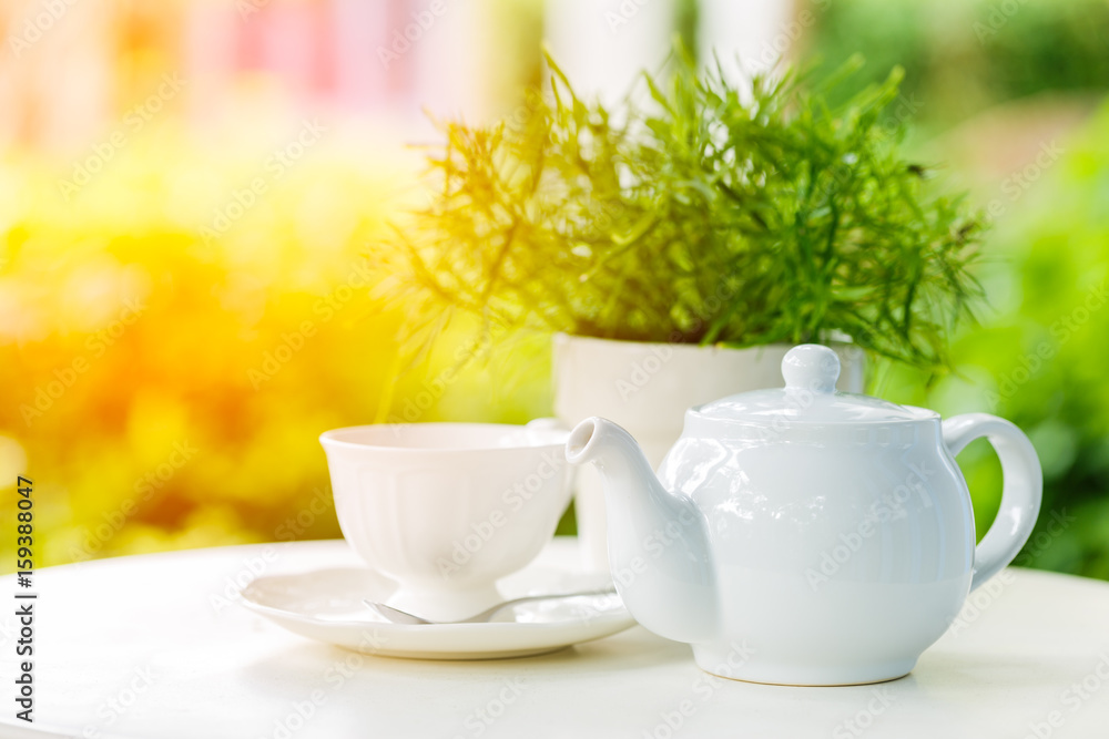 Cup of tea and teapot on a blurred background of nature Cup of tea and teapot on a blurred background of nature