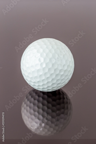 Close up the new white golf ball with the reflection, sport concept.