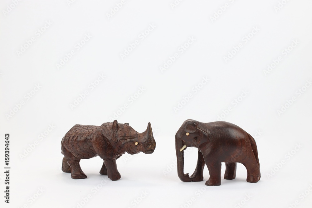 Hand carved rhinoceros and elephant facing each other Hand carved rhinoceros and elephant facing each other