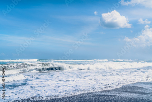 Beautiful Sea Splashing Wave on the Beach with Blue Sky Background. Tropical Nature Background. Paradise Sea Beach Island. Clean Ocean Dynamic Waves. Beach Landscape View. Sea Tropical Background