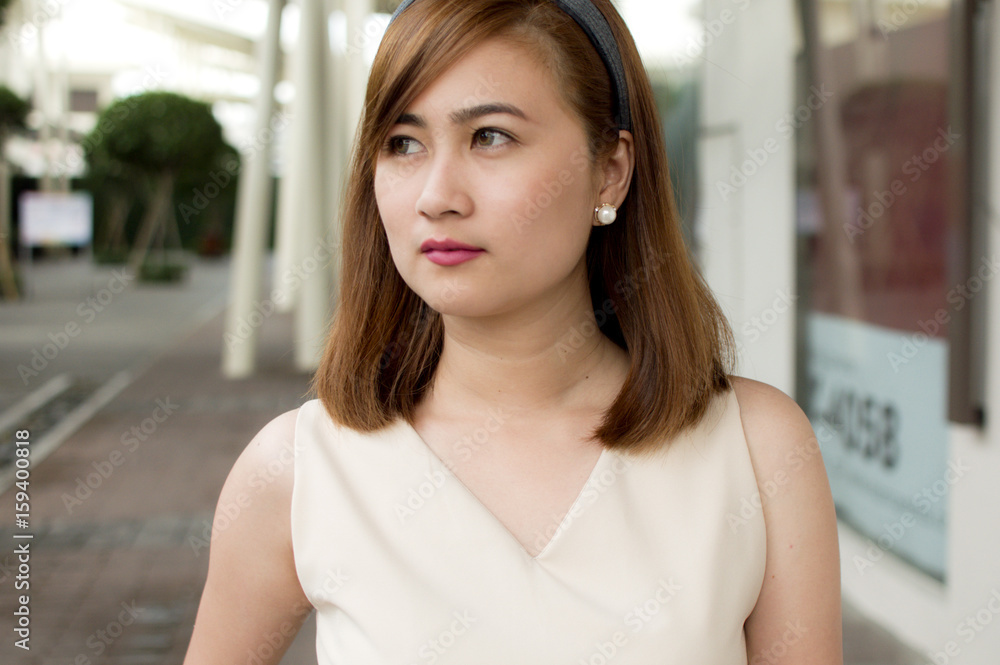 A portrait of a beautiful woman with cream silk top