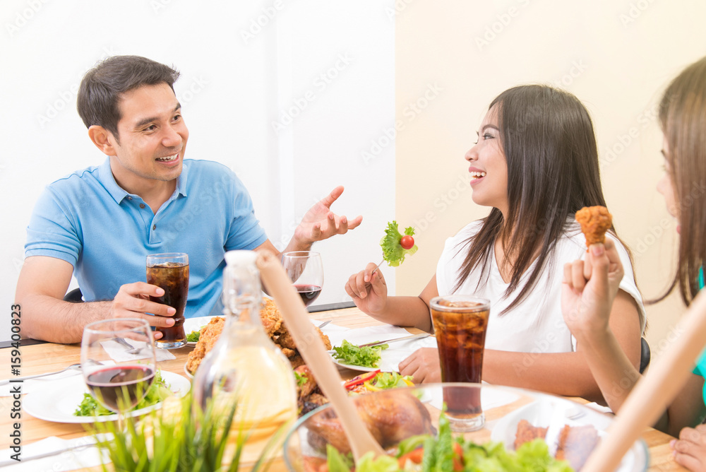 Asian family enjoying eating and having conversation Asian family enjoying eating and having conversation