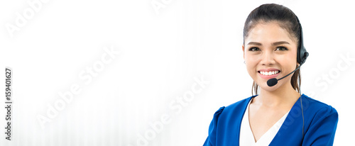 Canvas Print Smiling woman wearing microphone headset as an operator, telemarketer or call ce