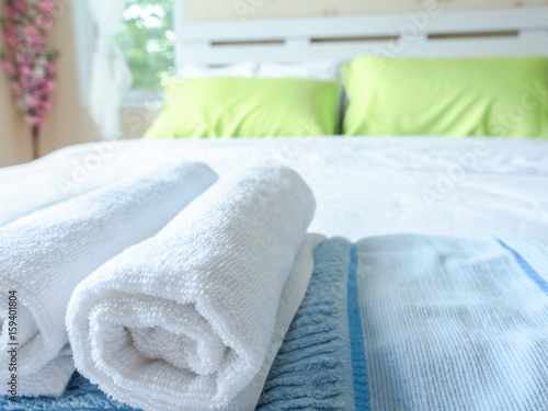 Selected focus on a white towel in the bedroom © rachaphak