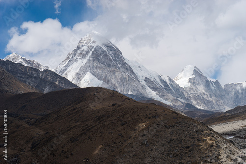 Pumori mountain peak in cloudy day, Everest region, Nepal