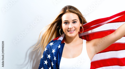 Young woman holding American flag