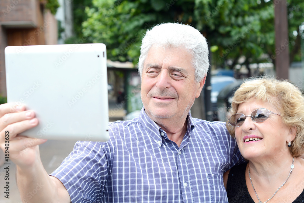Old couple taking selfie with tablet. Old couple taking selfie with tablet.