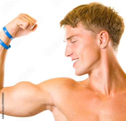 Happy smiling young man showing biceps, isolated