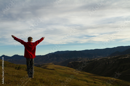 boy praising and enjoying mountains and landscape © Igno