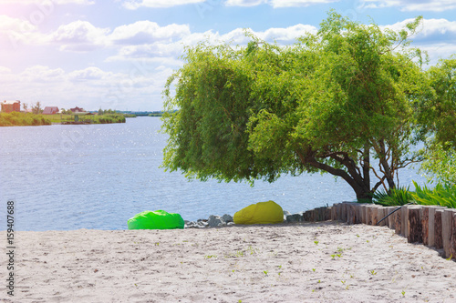 river beach with bean bag under tree