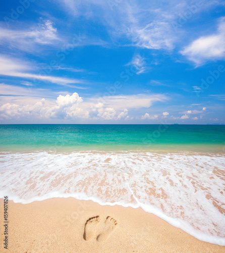 footprints on beach and tropical sea