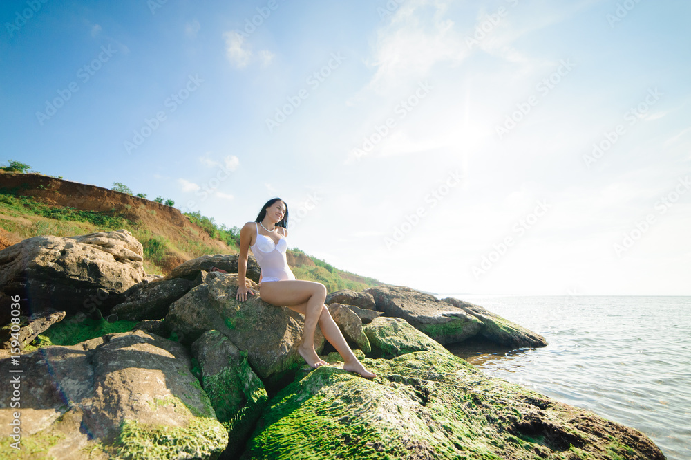 Beautiful naked girl sunbathing on the beach.