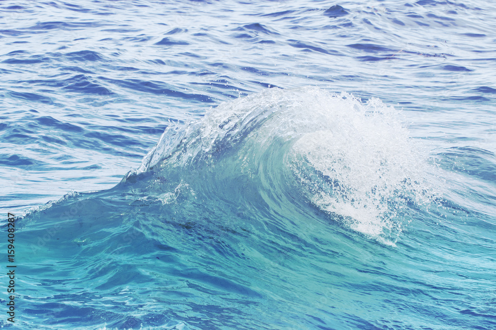 Turquoise blue wave on rippled sea water. Sea water closeup photo. Turquoise blue wave on rippled sea water. Sea water closeup photo.