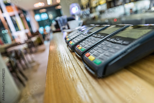 Credit card terminal in modern restaurant, blured background