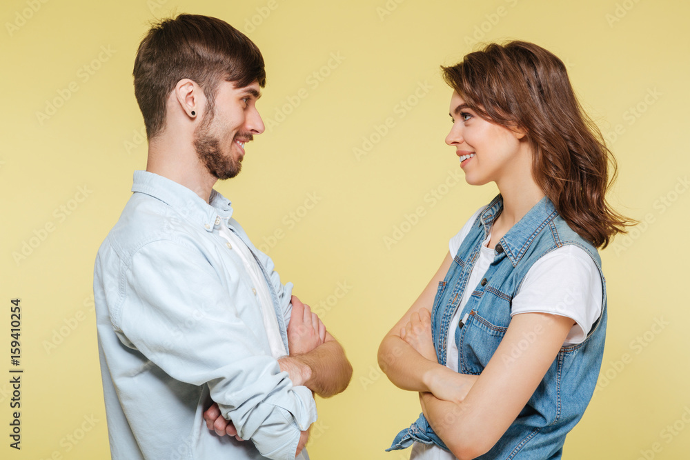 Happy brother and sister over yellow background Happy brother and sister over yellow background