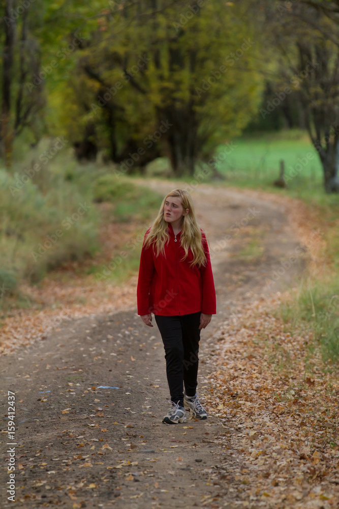 teenage girl in autumn road walking teenage girl in autumn road walking