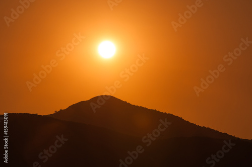 Orange sunset in the mountains. View from a height.