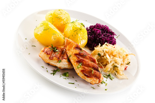 Grilled chicken fillet with boiled potatoes on white background 