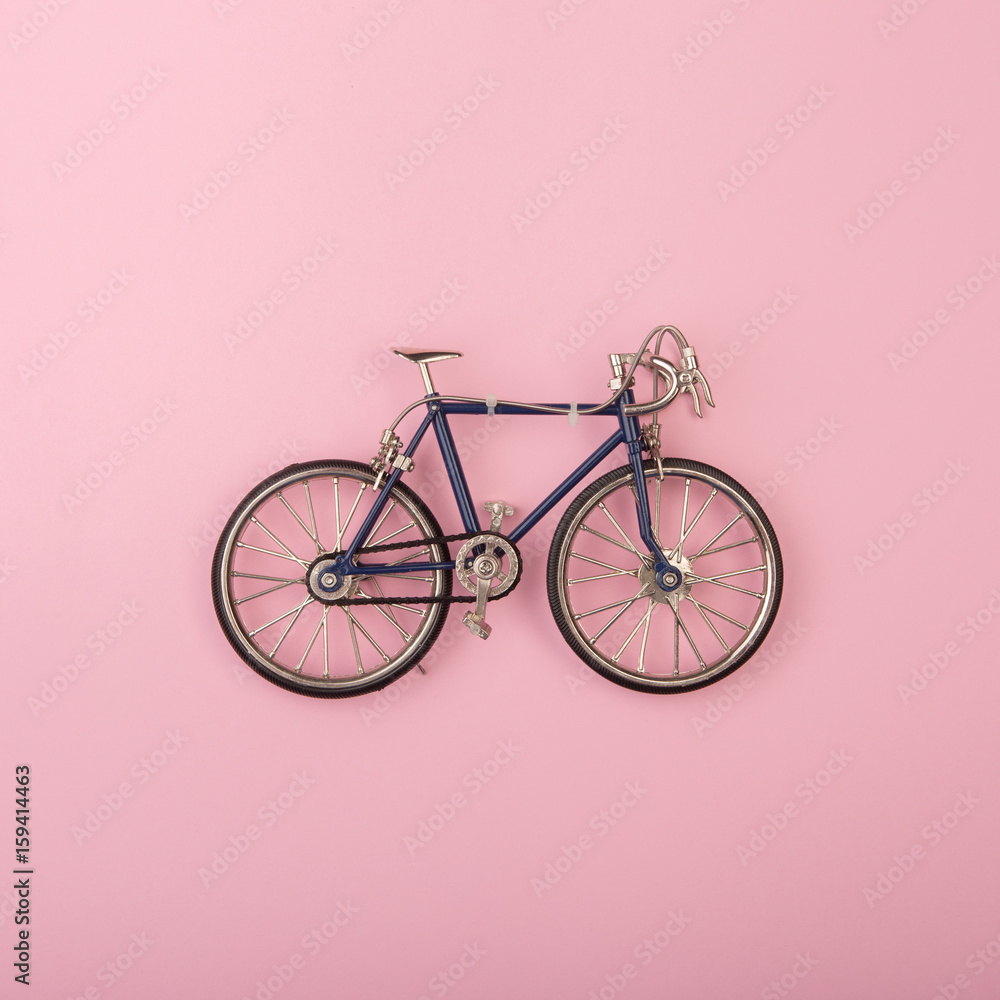 Sport concept - toy bicycles on pink background