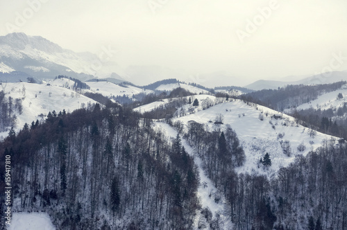 Idyllic winter landscape with mountains, sunny day; Bran, Romania