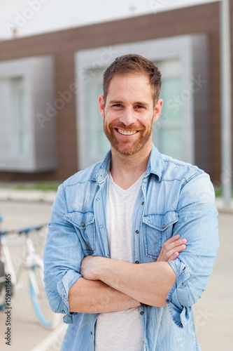 Casual guy with a denim shirt and crossing the arms