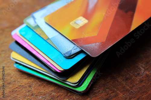Wallpaper Mural Big stack of different bright credit cards on a wooden background with selective focus, close up view. Torontodigital.ca