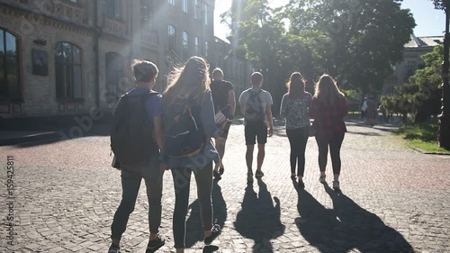Group of college students walking outdoors photo