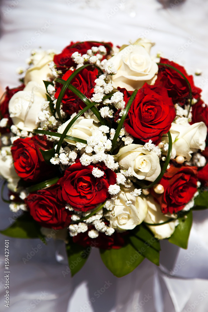 Bridal bouquet. The bride's . Beautiful of white flowers and greenery, decorated with silk ribbon, lies on vintage wooden chair Bridal bouquet. The bride's . Beautiful of white flowers and greenery, decorated with silk ribbon, lies on vintage wooden chair