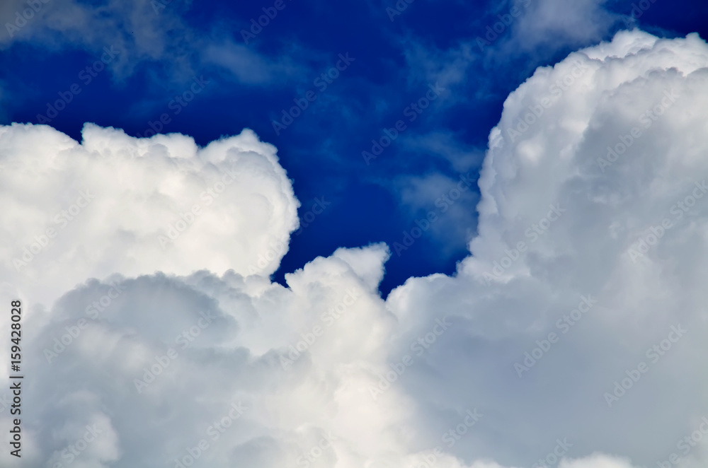 Blue sky with white and gray cumulus clouds. Closeup Blue sky with white and gray cumulus clouds. Closeup
