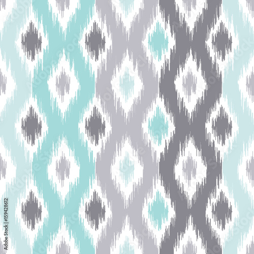Seamless geometric pattern, based on ikat fabric style. Vector illustration. Carpet rug texture vector imitation. Turquoise mint and grey ogee pattern.