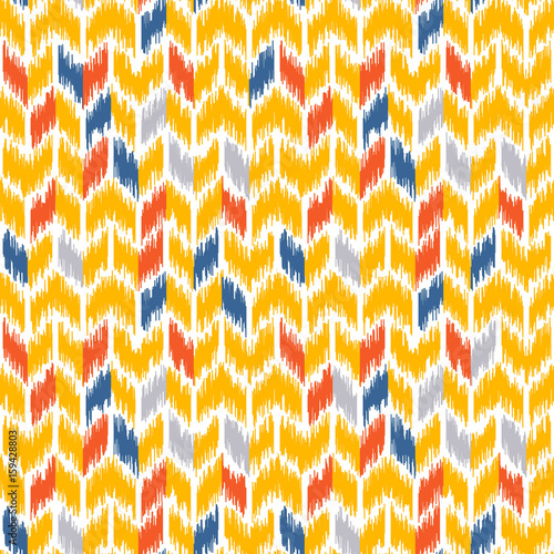 Seamless geometric pattern, based on ikat fabric style. Vector illustration. Carpet rug texture vector imitation. Yellow and gray chevron pattern.