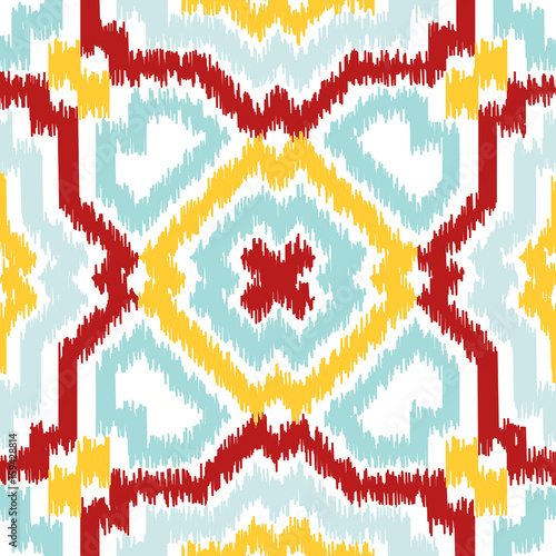 Seamless geometric pattern, based on ikat fabric style. Vector illustration. Carpet rug texture vector imitation. Colorful rug pattern in yellow, red, turquoise mint and white.