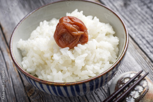 Traditional Japanese Koshihikari Rice with Umeboshi as close-up in a bowl