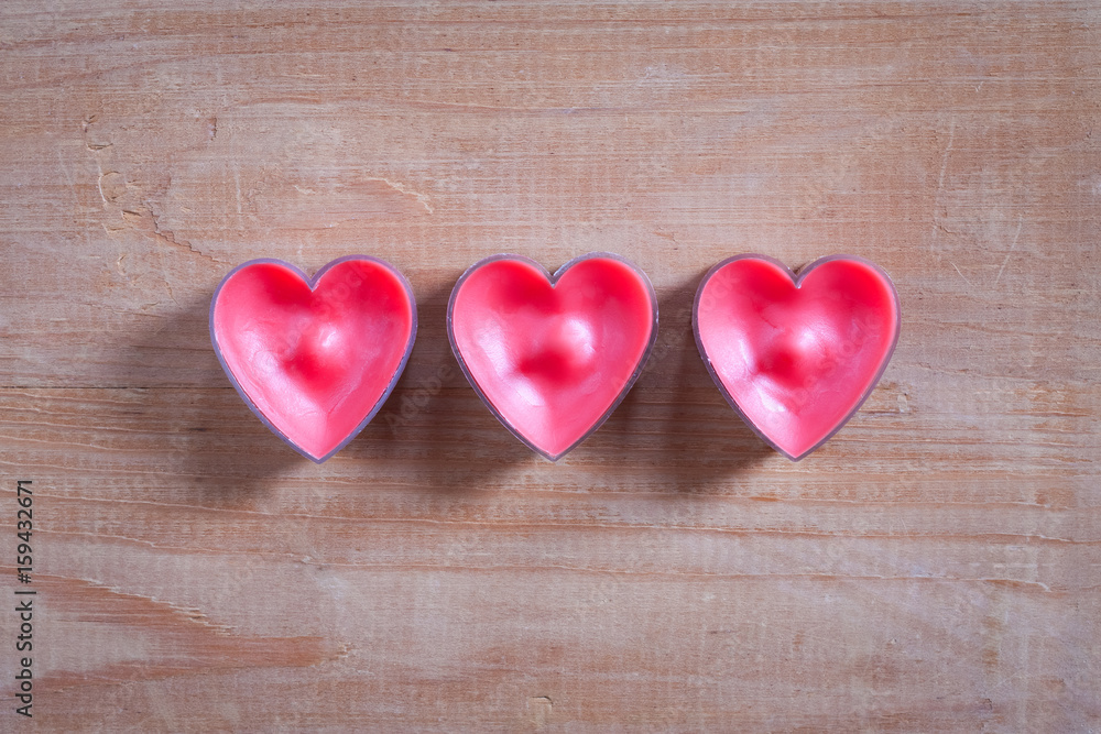 Three Red Heart Shapes On Old Wooden Brown Board Background Copyspace. Three Red Heart Shapes On Old Wooden Brown Board Background Copyspace.