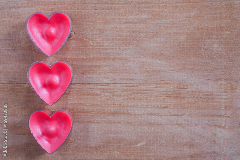 Three Red Heart Shapes On Wooden Board Background Copyspace. Three Red Heart Shapes On Wooden Board Background Copyspace.