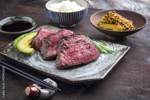 Japanese Kobe Steak Fillet with Rice and Avocado as close-up on a plate