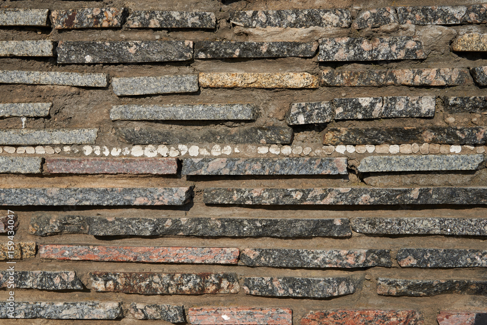 Detail of a wall of thin granite slabs. Texture, background