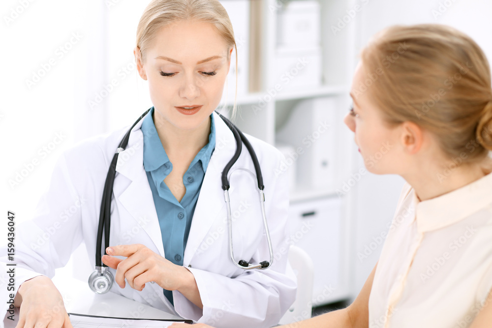 Doctor and patient sitting at the desk Doctor and patient sitting at the desk
