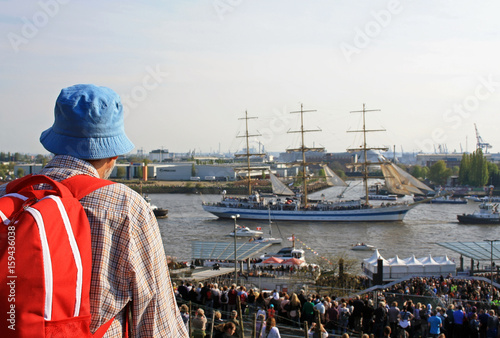 A tourist is watching ship's parade at Hamburg port birthday