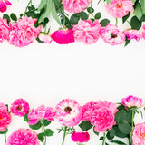 Frame of pink roses, ranunculus and leaves on white background. Floral lifestyle composition. Flat lay, top view.