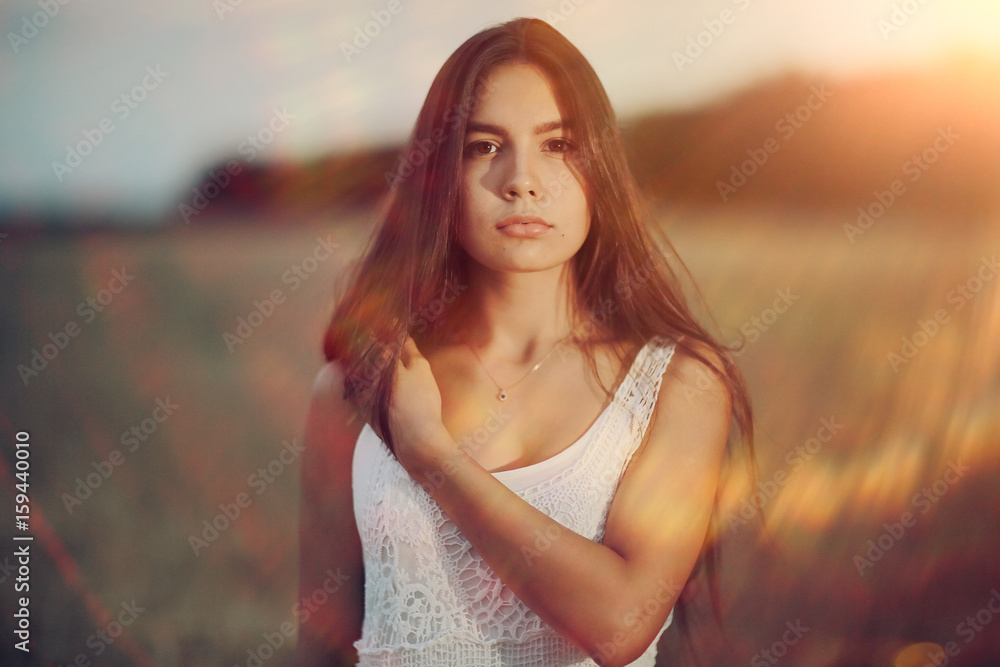Young glamorous model posing in a field wheat Young glamorous model posing in a field wheat