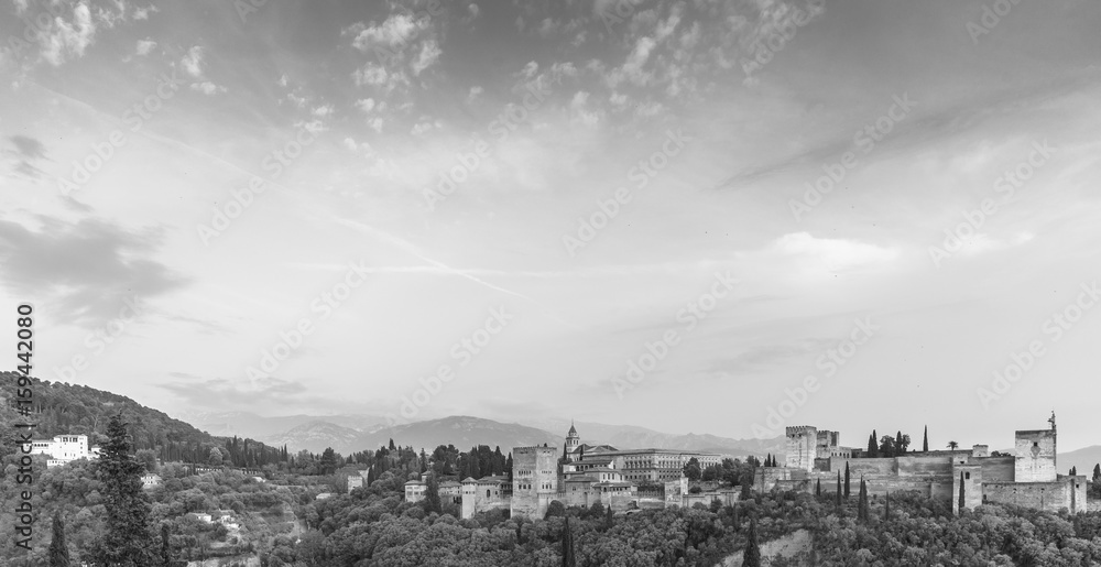 Black and white image of landscape of Alhambra of Granada, Spain, from Albaycin with Sierra Nevada's mountain on the background