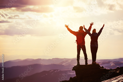 Happy couple sunset winners mountain top