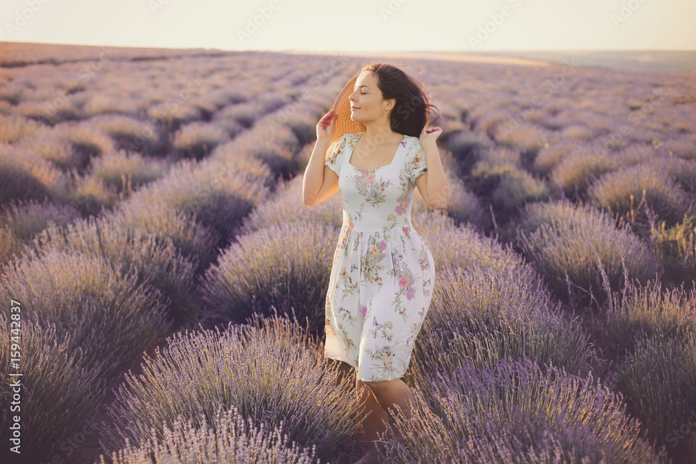 Beautiful young woman wearing a vintage dress and Straw hat walk in ...