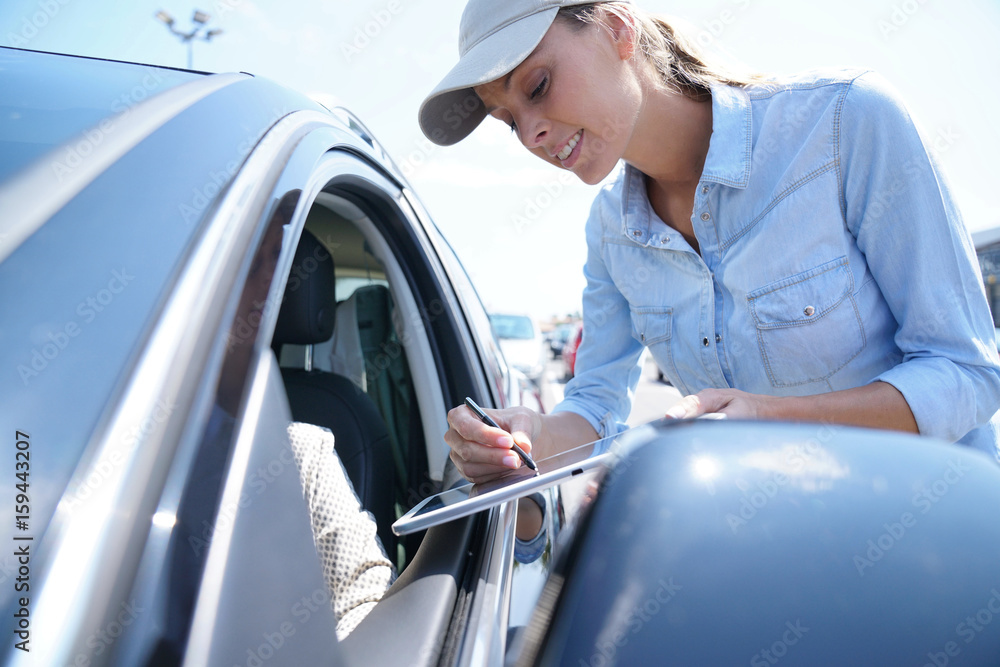 Woman stopping car driver for customer survey Woman stopping car driver for customer survey