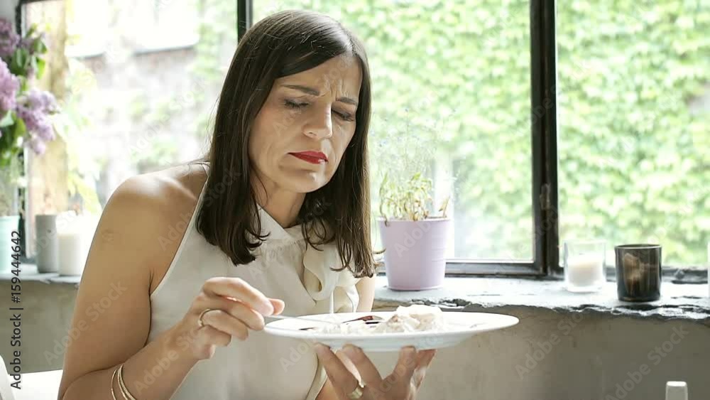 Elegant woman having indigestion while eating dessert in the cafe, steadycam shot
Elegant woman having indigestion while eating dessert in the cafe, steadycam shot